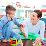 Mother and son playing on floor